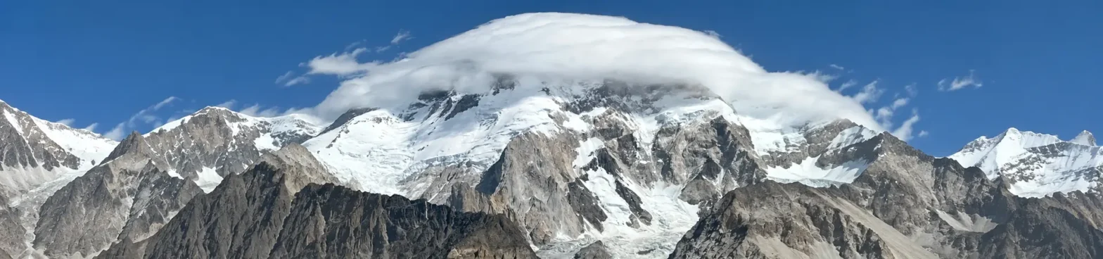 Snow-capped Broad Peak rises majestically against a clear blue sky, showcasing its stunning glacial landscape.